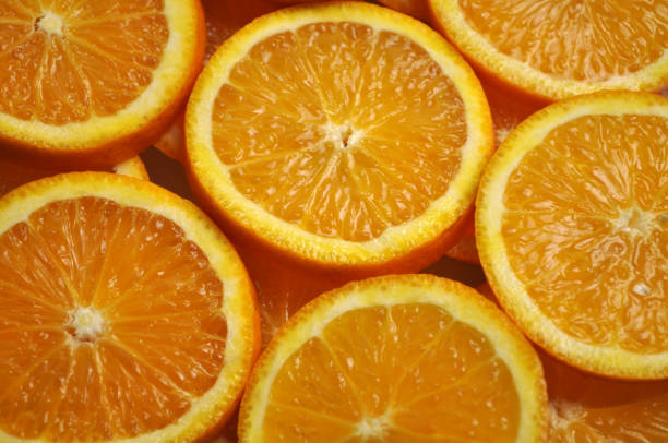 istock tropical citrus fruit - bright orange orange sliced into slices 1066472352