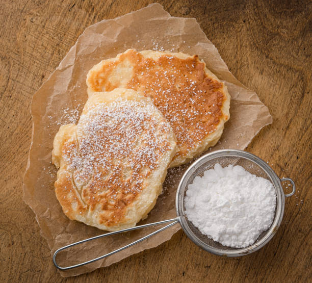 pancakes and strainer with powdered sugar stock photo