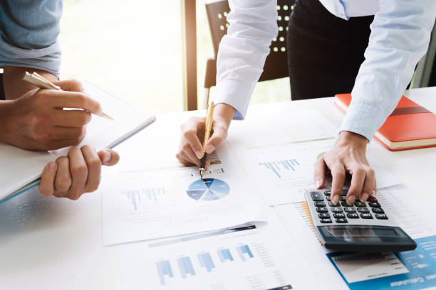 istock Business people using pen,tablet,notebook are planning a marketing plan to improve the quality of their sales in the future. 1066475726