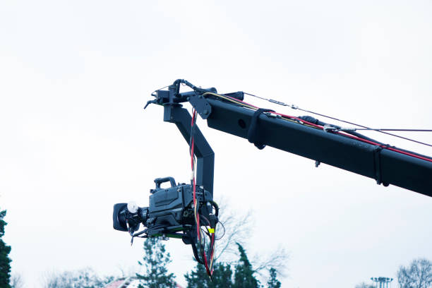 istock Technology equipment tv digital video camera on a crane isolated on the cloudy sky background with a copy space 1066484868
