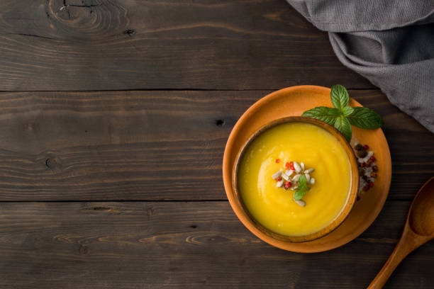 istock Pumpkin soup mashed with spices in wooden bowls on dark boards. 1066488222