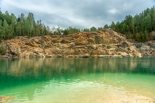 Closed down limestone quarry in Sweden that today serves as a bathing place, with crystal clear emerald green water