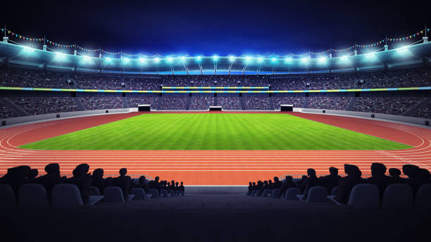 athletics stadium with track and grass field at side night view - sports track track and field stadium sport night imagens e fotografias de stock