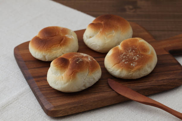 istock baked white bread on wood cutting board isolated on table 1066492330