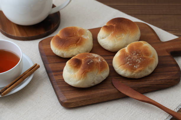 istock baked white bread tea cup on wood cutting board isolated on table 1066492548