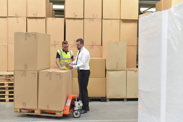 istock Worker and businessman in a warehouse in the logistics sector - transport and processing of orders in trade 1066494214