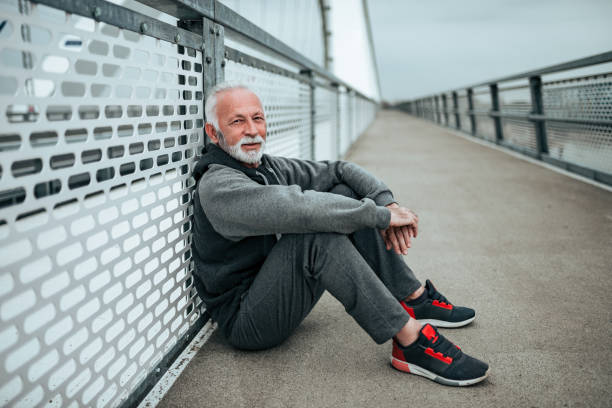 istock Senior sportsman relaxing after workout in the city environment. 1066494708