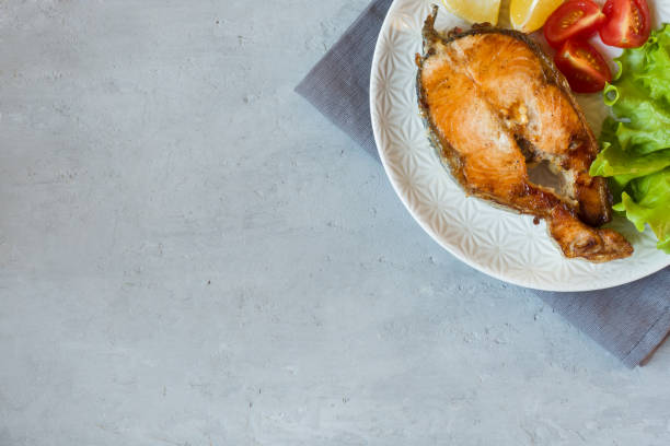 istock Steak baked salmon fish on a plate with fresh vegetables. 1066495128