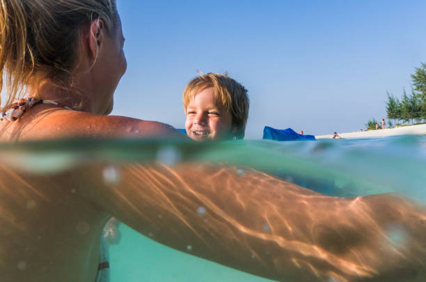 istock Cute boy having fun with his mother in the sea. 1066496516