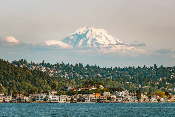 Mt Rainier above Seattle, WA Mount Rainier emerging from the clouds above Seattle from Elliott Bay, Puget Sound, Washington state, USA. puget sound stock pictures, royalty-free photos & images