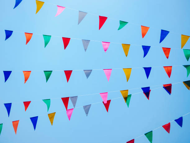 istock Festival outdoor colourful flags decoration with blue sky background 1066499234