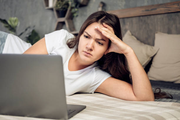 istock girl  with laptop on bed 1066503604