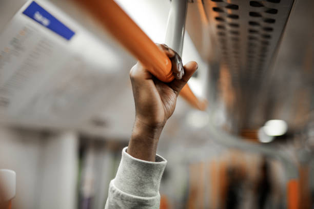 istock Man holding on to a handrail on a train 1066504048