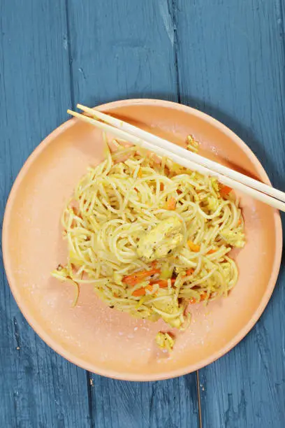 Chinese noodles in plate. Above view vertical shot