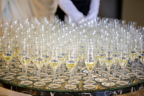 istock Elegant glasses with champagne standing in a row on serving table during party or celebration 1066506194