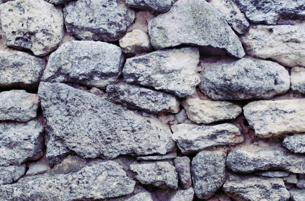 istock Unusual background with raw natural porous stone. 1066507942