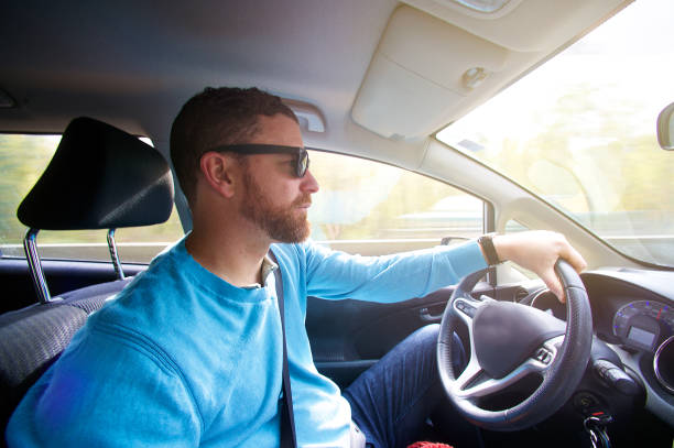 istock Hipster male with sunglasses driving his car 1066513190