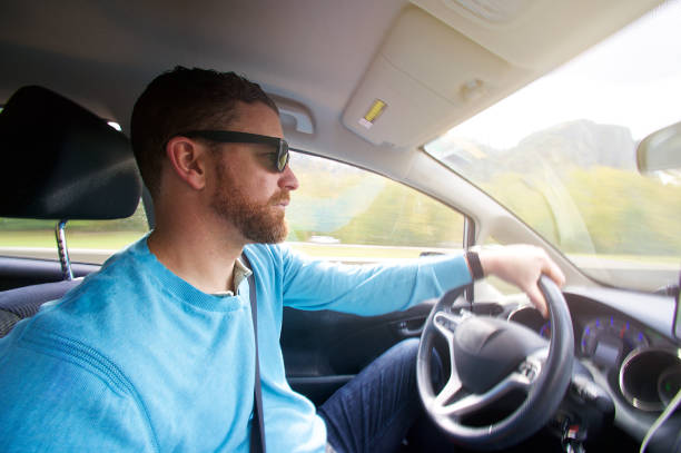 istock Hipster male with sunglasses driving a car 1066513266