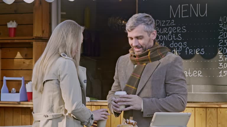 Man and woman drink coffee outdoor coffee shop