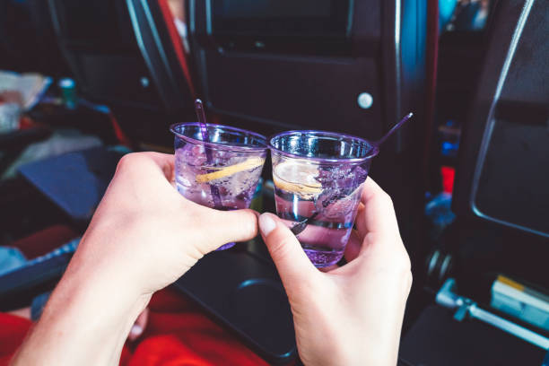 Young couple drinking gin on the airplane