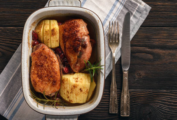 istock Roasted duck breast with apples and cranberries. 1066520888
