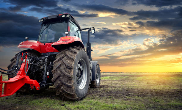 istock Agricultural tractor working in the field at sunset background 1066523278