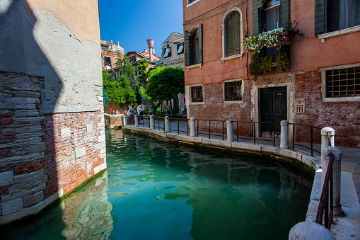 Italy, Venice, August 23, 2010: View of the elegant turn of the canal and old houses.
