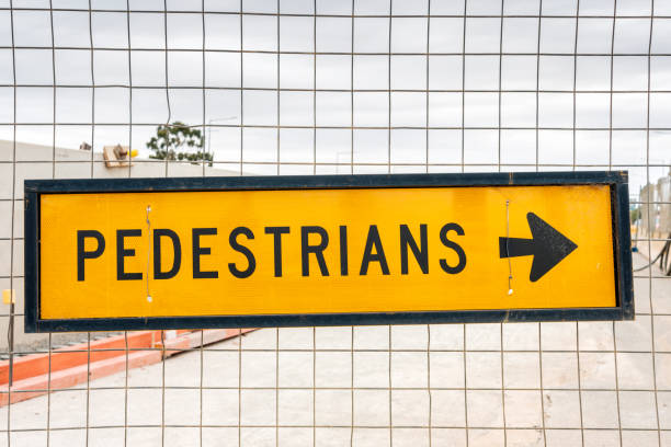 australian pedestrians sign - arrow sign road sign fence imagens e fotografias de stock