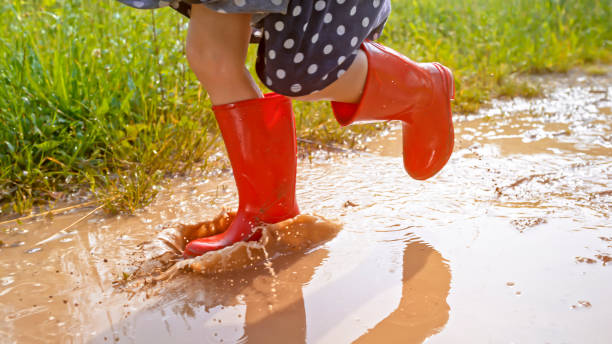 istock Girl walking in muddy water 1066529858