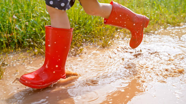 istock Girl walking in muddy water 1066529860
