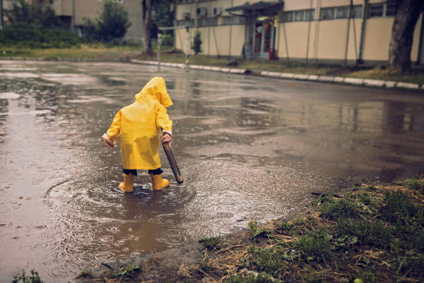 istock Cute little boy playing outdoors at rainy day 1066533016