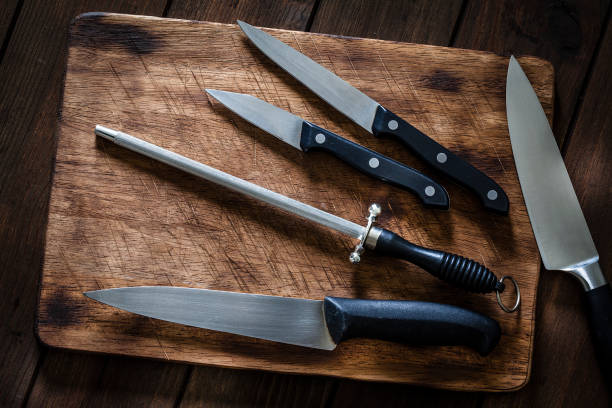 istock Sharpening steel and various kitchen knives on wooden cutting board 1066533044