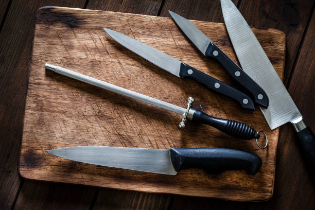 istock Sharpening steel and various kitchen knives on wooden cutting board 1066533360