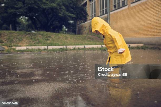 Adorable Little Boy Playing At Rainy Day Stock Photo - Download Image Now - Rain, Child, Autumn