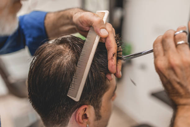 istock Man getting modern haircut at barber shop 1066536542