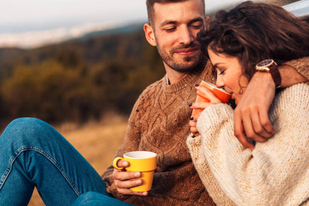 istock Beautiful young couple enjoying picnic time on the sunset. 1066538016