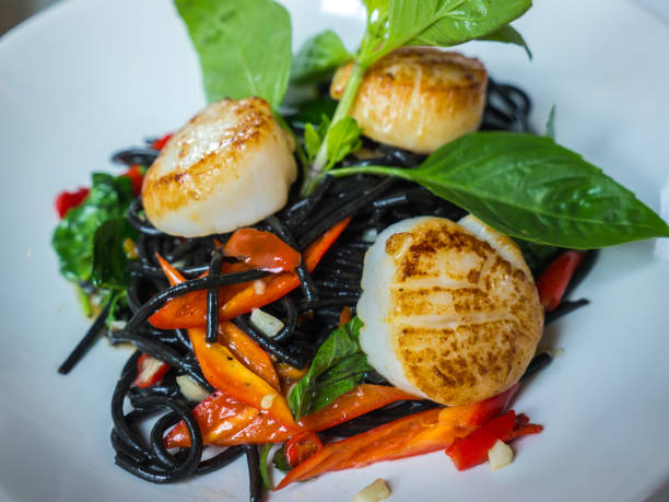 Stir-fried black spaghetti scallop with chili sauce stock photo