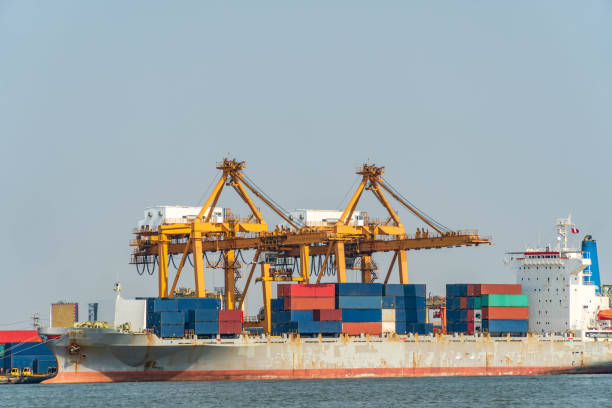 istock Container ship with crane bridge, working for export and import business in the sea. 1066544400