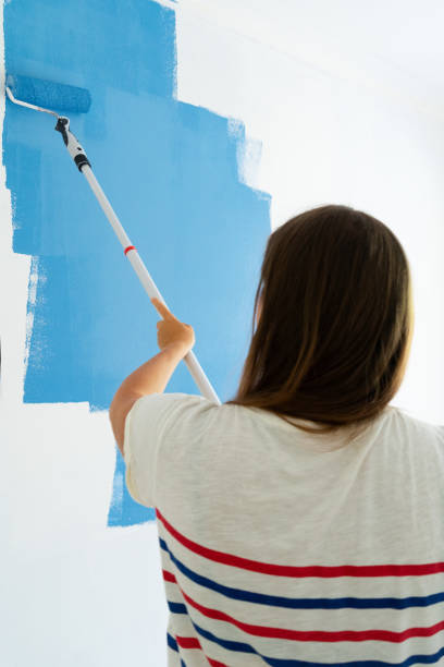 istock Woman painting wall 1066545402