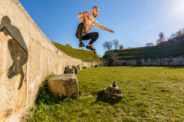 istock Handsome Body builder Man does phisical exercises outdoor. Innovative Gym in an ancient Roman amphitheater 1066549268