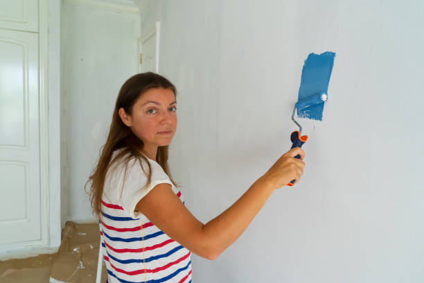 istock Woman painting wall 1066553252