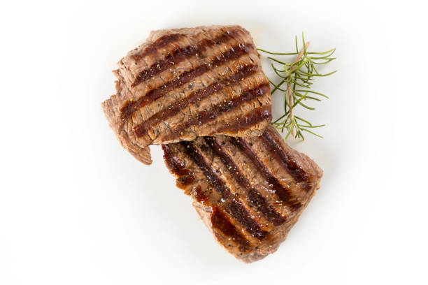 istock Two steaks and rosemary on a white background. 1066554614