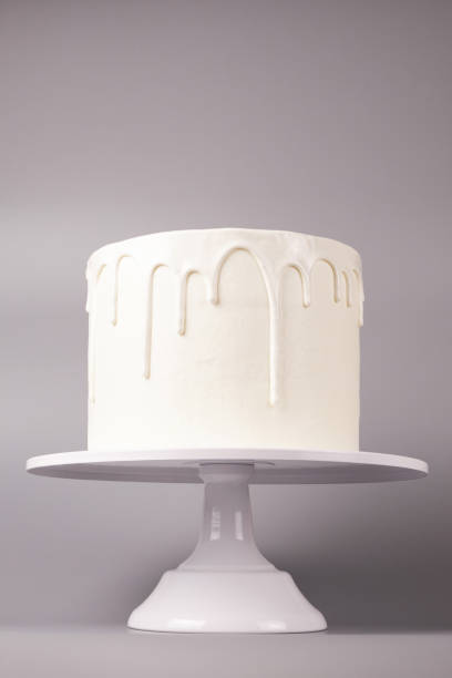 istock Simple white cake with glaze on a gray background. 1066555216