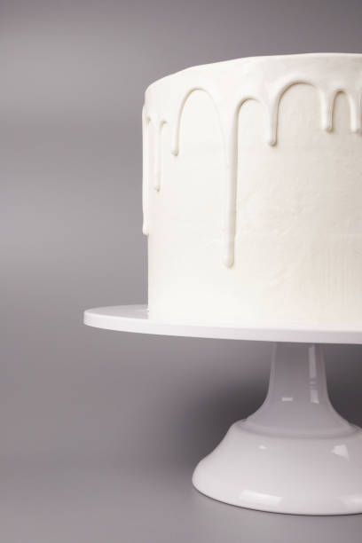 istock Simple white cake with glaze on a gray background. 1066555234