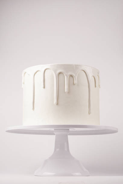 istock Simple white cake with glaze on a white background. 1066555372