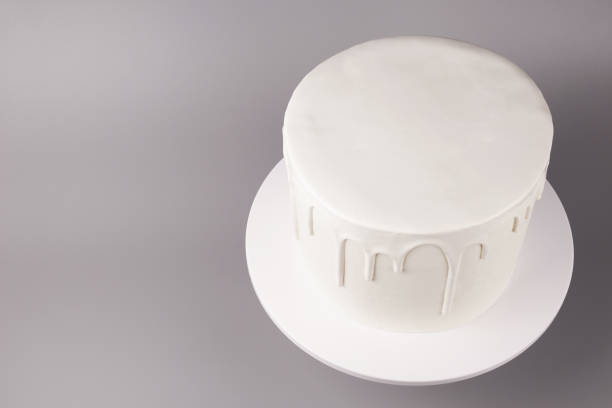 istock Simple white cake with glaze on a gray background. 1066555376