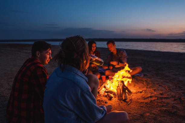 istock young friends have picnic with bonfire on the beach 1066555930