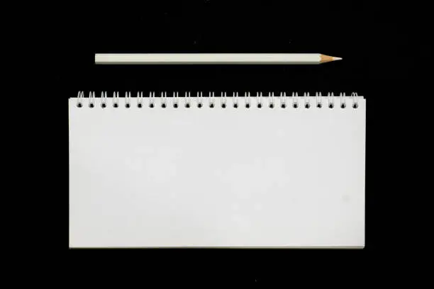 black table with white empty notepad and pencil