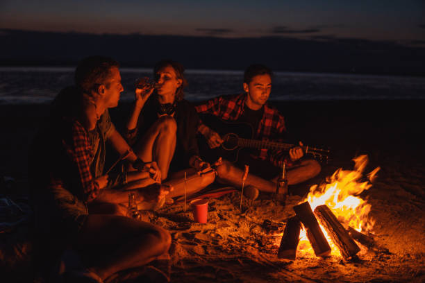 istock young friends have picnic with bonfire on the beach 1066557570