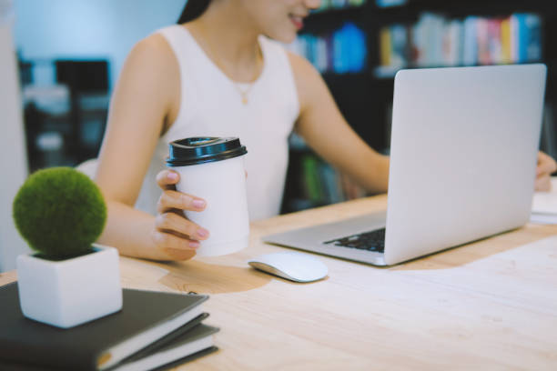 istock Women business in hands while having coffee and working new projects in laptop at office.Teamwork successful Meeting Workplace strategy Concept. 1066558160